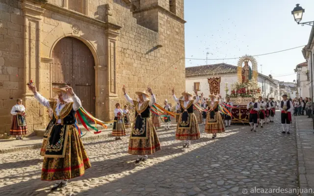 A traditional Spanish religious procession in a small Castilla-La Mancha village, with dancers in colorful traditional cos...