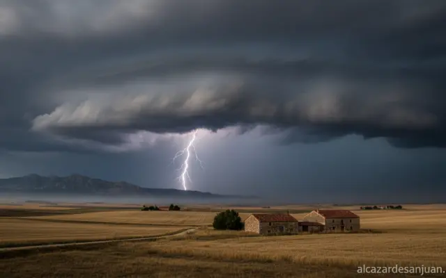 Realistic photojournalistic image of a dramatic storm sky with dark rain clouds and lightning over a Spanish rural landsca...