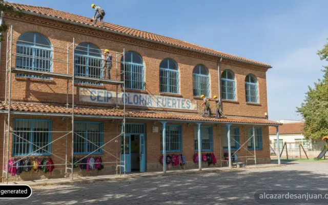 Realistic photojournalistic shot of a Spanish public primary school building exterior, workers finishing a roof repair wit...